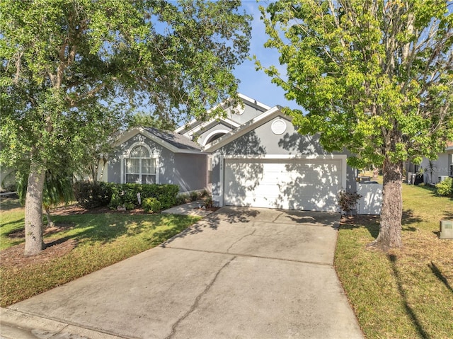 166 Laurel Ridge Pass, Davenport, FL 33897 - view of front of property with stucco siding, a front yard, driveway, and an attached garage