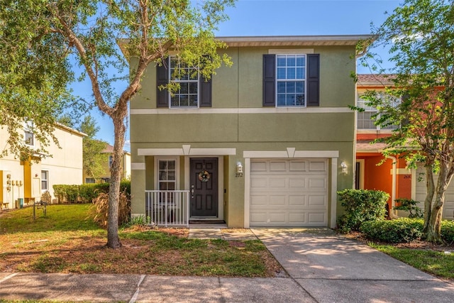 272 Glowing Peace Ln Unit 48, Orlando, FL 32824 - traditional-style house with an attached garage, driveway, and stucco siding