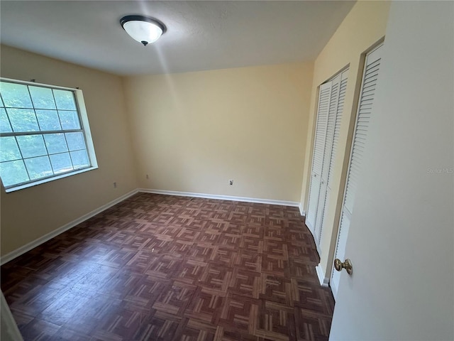 2102 69th Dr, Gainesville, FL 32608 - unfurnished bedroom with baseboards and multiple closets