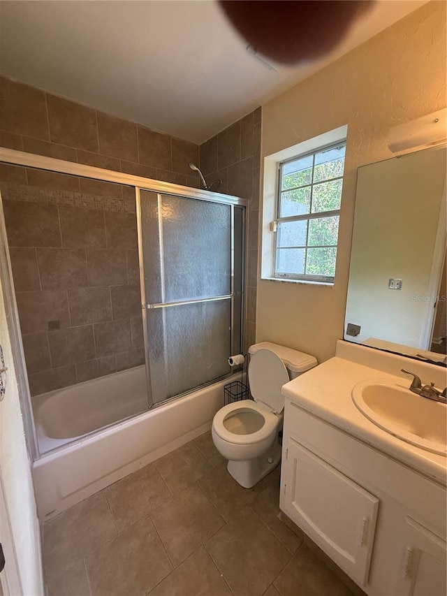 2102 69th Dr, Gainesville, FL 32608 - bathroom with tile patterned floors, vanity, bath / shower combo with glass door, and toilet