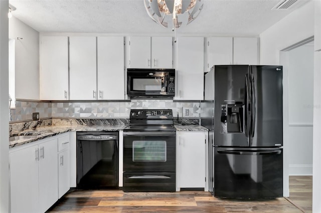 4216 Lake Underhill Rd Unit 6A2-8, Orlando, FL 32803 - kitchen featuring decorative backsplash, black appliances, white cabinetry, stone countertops, and wood finished floors