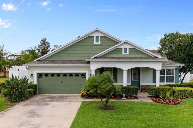690 Cascading Creek Ln, Winter Garden, FL 34787 - view of front of house featuring a shingled roof, a front lawn, a garage, covered porch, and driveway