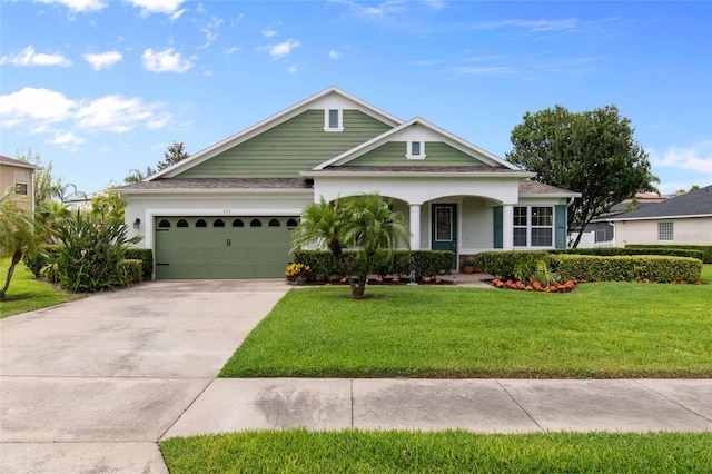 690 Cascading Creek Ln, Winter Garden, FL 34787 - view of front of home featuring covered porch, a front yard, stucco siding, concrete driveway, and an attached garage