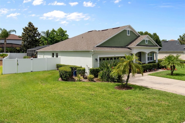690 Cascading Creek Ln, Winter Garden, FL 34787 - view of front of house featuring a garage, a front lawn, roof with shingles, and fence