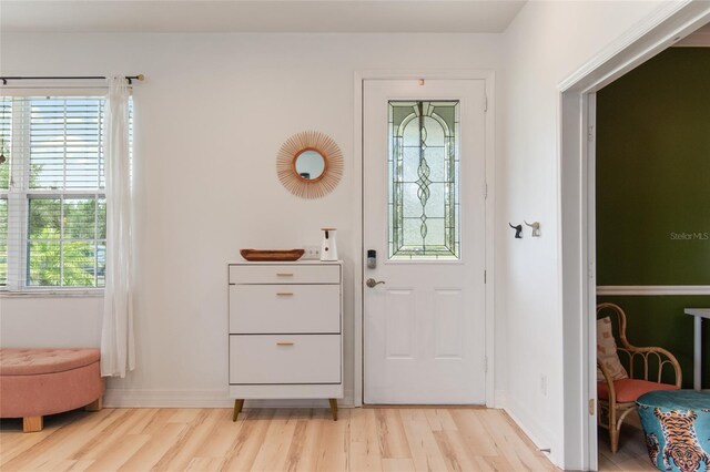 690 Cascading Creek Ln, Winter Garden, FL 34787 - doorway to outside with baseboards and light wood finished floors