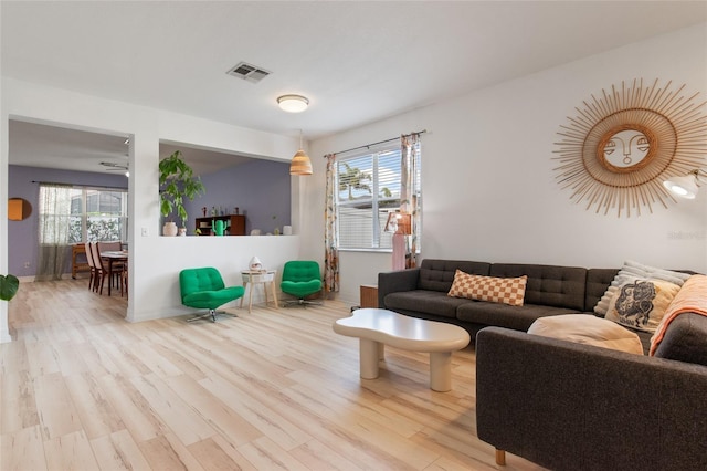 690 Cascading Creek Ln, Winter Garden, FL 34787 - living area featuring a wealth of natural light, wood finished floors, and visible vents
