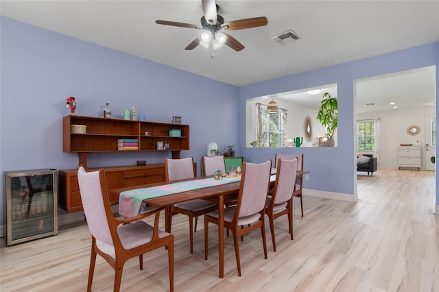 690 Cascading Creek Ln, Winter Garden, FL 34787 - dining room with a ceiling fan, visible vents, baseboards, beverage cooler, and light wood-style floors