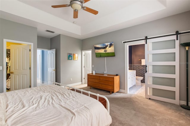 690 Cascading Creek Ln, Winter Garden, FL 34787 - bedroom featuring visible vents, a barn door, baseboards, light carpet, and a tray ceiling