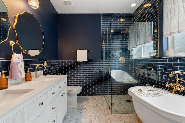 690 Cascading Creek Ln, Winter Garden, FL 34787 - bathroom with a tile shower, a sink, toilet, tile walls, and a soaking tub