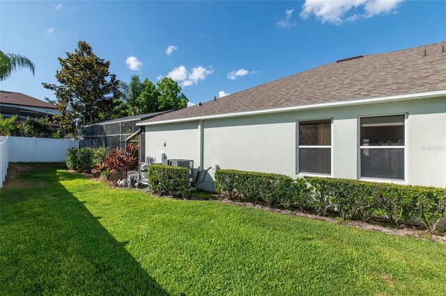 690 Cascading Creek Ln, Winter Garden, FL 34787 - exterior space featuring a fenced backyard, glass enclosure, and central AC unit