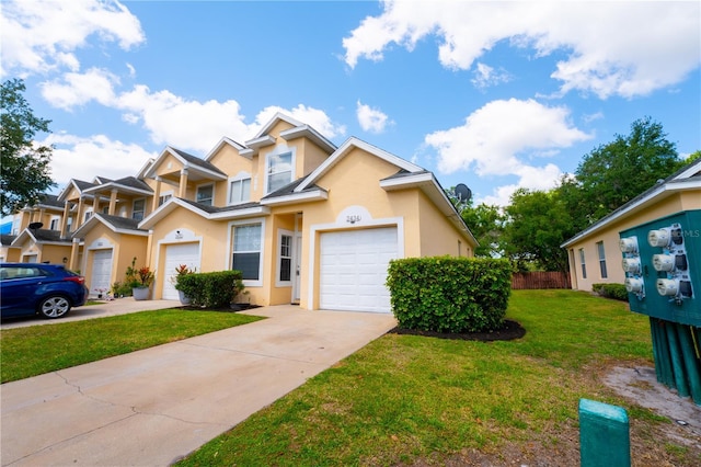 2434 Temple Grove Ln, Kissimmee, FL 34741 - view of front facade with fence, driveway, a front yard, and stucco siding