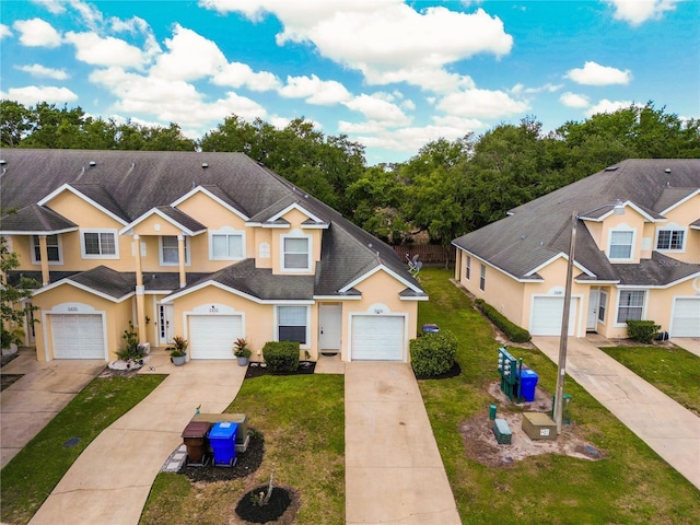 2434 Temple Grove Ln, Kissimmee, FL 34741 - view of front facade with stucco siding, driveway, and a front yard