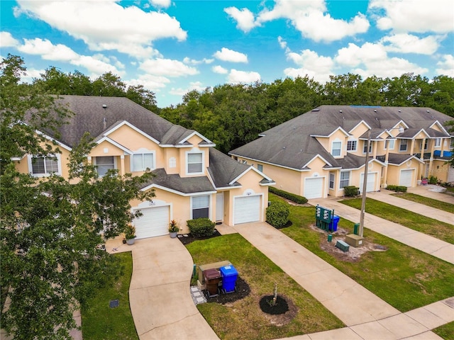 2434 Temple Grove Ln, Kissimmee, FL 34741 - view of front of property featuring stucco siding, a garage, and concrete driveway
