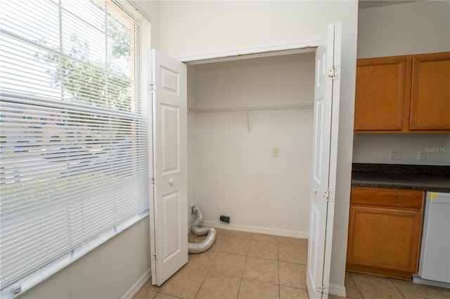 2434 Temple Grove Ln, Kissimmee, FL 34741 - laundry area with baseboards, light tile patterned flooring, and laundry area