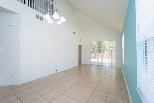 2434 Temple Grove Ln, Kissimmee, FL 34741 - empty room with high vaulted ceiling, a chandelier, light tile patterned floors, baseboards, and visible vents