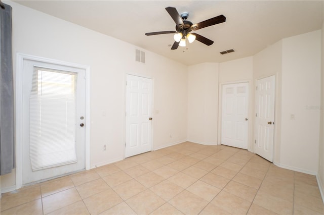 2434 Temple Grove Ln, Kissimmee, FL 34741 - spare room with light tile patterned floors, baseboards, visible vents, and ceiling fan