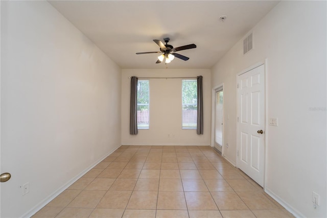 2434 Temple Grove Ln, Kissimmee, FL 34741 - empty room featuring light tile patterned flooring, visible vents, a ceiling fan, and baseboards