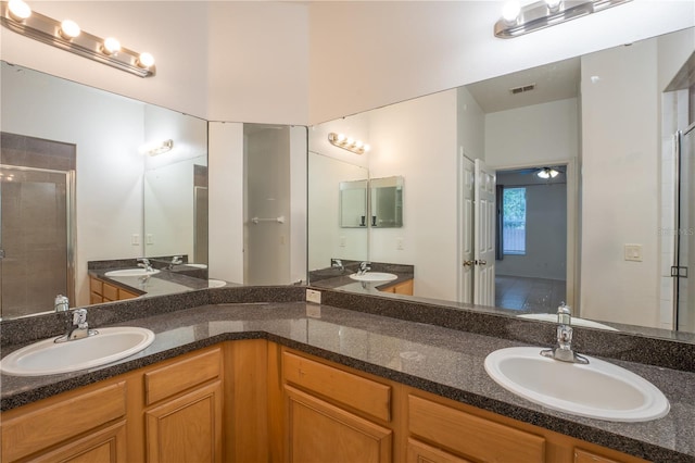 2434 Temple Grove Ln, Kissimmee, FL 34741 - bathroom with double vanity, a shower stall, visible vents, and a sink