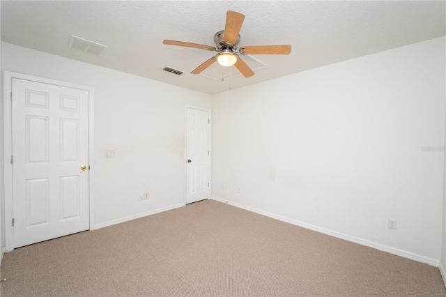 2434 Temple Grove Ln, Kissimmee, FL 34741 - spare room with visible vents, a ceiling fan, baseboards, and light carpet