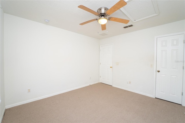 2434 Temple Grove Ln, Kissimmee, FL 34741 - unfurnished room with attic access, light carpet, baseboards, visible vents, and a ceiling fan