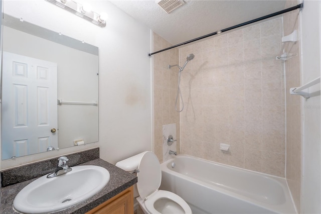 2434 Temple Grove Ln, Kissimmee, FL 34741 - full bathroom featuring a textured ceiling, toilet, visible vents, shower / bath combination, and vanity