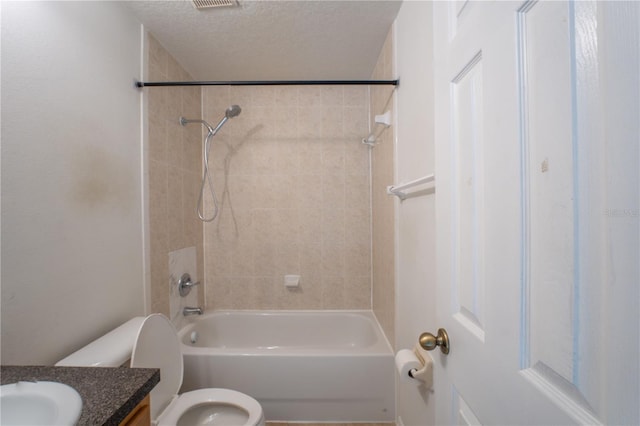 2434 Temple Grove Ln, Kissimmee, FL 34741 - bathroom featuring a textured ceiling, vanity, shower / washtub combination, toilet, and visible vents