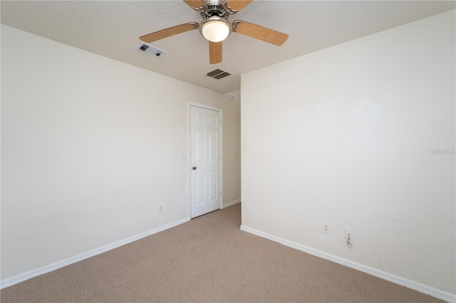 2434 Temple Grove Ln, Kissimmee, FL 34741 - empty room featuring light carpet, baseboards, visible vents, and a ceiling fan