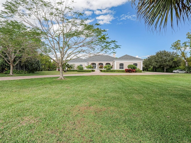 2266 12th St, Vero Beach, FL 32960 - ranch-style house with stucco siding, a front lawn, and a chimney