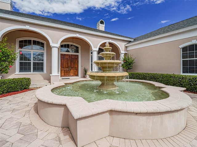 2266 12th St, Vero Beach, FL 32960 - property entrance featuring a chimney and stucco siding