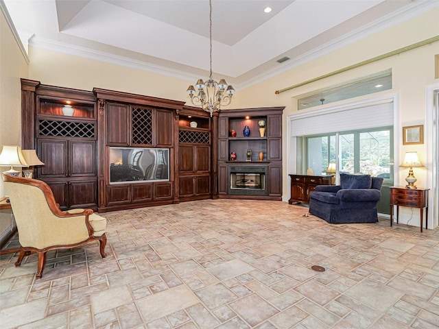 2266 12th St, Vero Beach, FL 32960 - living room with visible vents, an inviting chandelier, a raised ceiling, and stone finish flooring