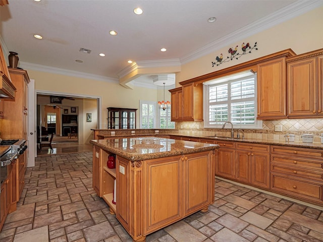 2266 12th St, Vero Beach, FL 32960 - kitchen with decorative backsplash, a peninsula, a sink, and light stone counters