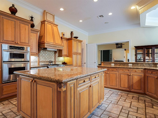 2266 12th St, Vero Beach, FL 32960 - kitchen featuring tasteful backsplash, visible vents, recessed lighting, a kitchen island, and double oven