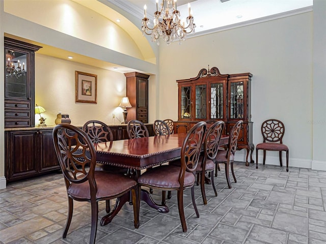 2266 12th St, Vero Beach, FL 32960 - dining room with a towering ceiling, ornamental molding, stone tile flooring, baseboards, and a notable chandelier