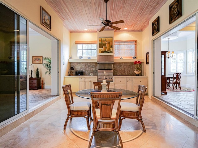 2266 12th St, Vero Beach, FL 32960 - dining space with a fireplace, crown molding, wooden ceiling, and ceiling fan with notable chandelier