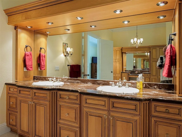 2266 12th St, Vero Beach, FL 32960 - bathroom featuring recessed lighting, an inviting chandelier, double vanity, and a sink