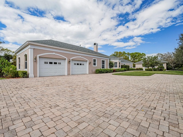 2266 12th St, Vero Beach, FL 32960 - single story home featuring a garage, stucco siding, a chimney, and decorative driveway