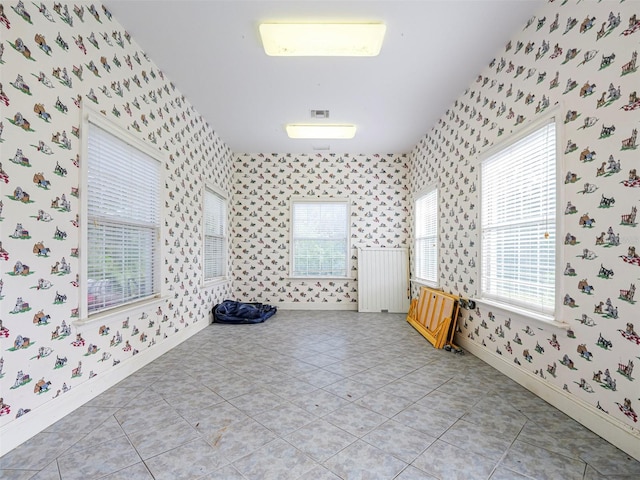 2266 12th St, Vero Beach, FL 32960 - unfurnished room featuring wallpapered walls, baseboards, and light tile patterned floors