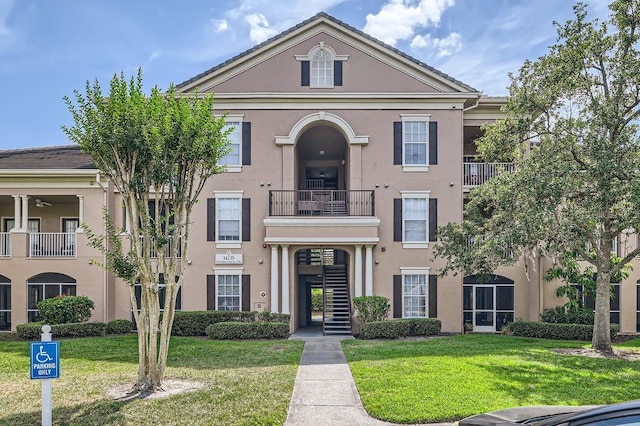 14238 Fredricksburg Dr Unit 310, Orlando, FL 32837 - view of front facade featuring stucco siding and a front yard