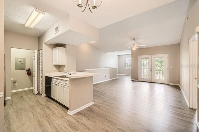 14238 Fredricksburg Dr Unit 310, Orlando, FL 32837 - kitchen with light wood finished floors, a sink, visible vents, light countertops, and ceiling fan with notable chandelier