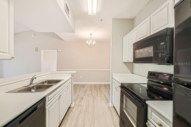 14238 Fredricksburg Dr Unit 310, Orlando, FL 32837 - kitchen featuring white cabinetry, a sink, light wood-style floors, light countertops, and black appliances