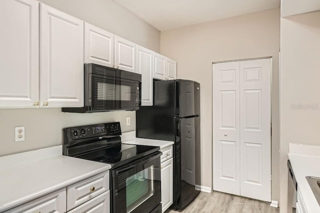14238 Fredricksburg Dr Unit 310, Orlando, FL 32837 - kitchen featuring black appliances, light wood-style floors, light countertops, and white cabinetry