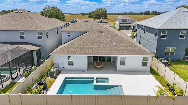 4779 Cragmere Loop, Clermont, FL 34711 - rear view of property featuring cooling unit, a patio, a shingled roof, stucco siding, and a fenced backyard