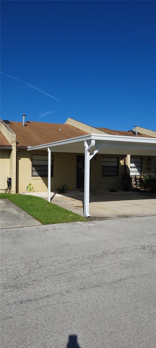 view of property exterior featuring a carport