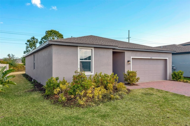439 Sarah Nicole Way, New Smyrna Beach, FL 32168 - ranch-style home featuring stucco siding, a front yard, decorative driveway, and a garage