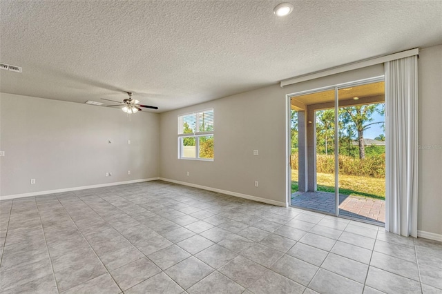 439 Sarah Nicole Way, New Smyrna Beach, FL 32168 - unfurnished room with tile patterned flooring, visible vents, baseboards, a textured ceiling, and ceiling fan