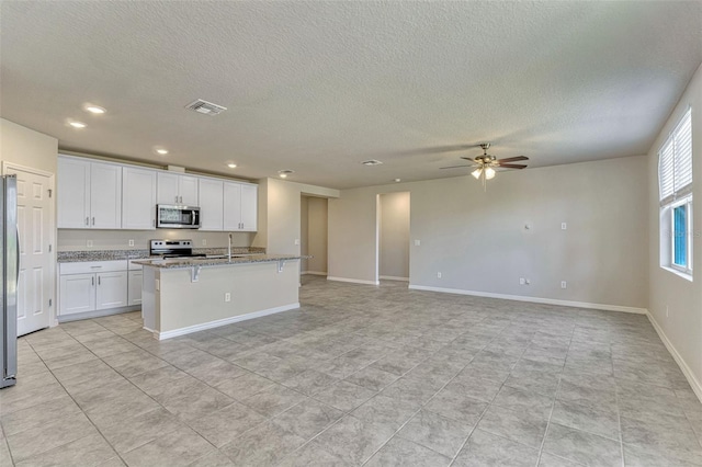 439 Sarah Nicole Way, New Smyrna Beach, FL 32168 - kitchen with a textured ceiling, ceiling fan, visible vents, and stainless steel appliances