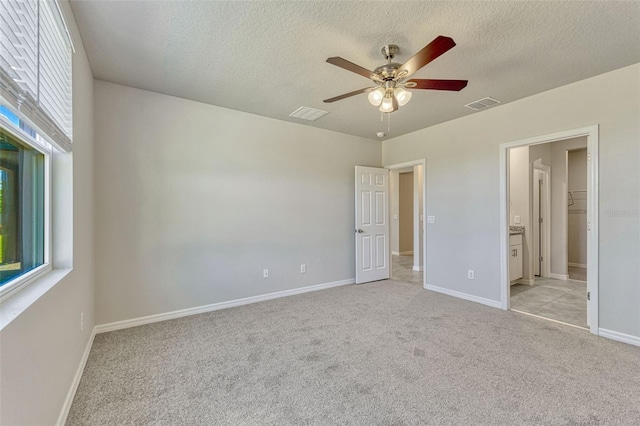 439 Sarah Nicole Way, New Smyrna Beach, FL 32168 - unfurnished bedroom with visible vents, a textured ceiling, and light colored carpet