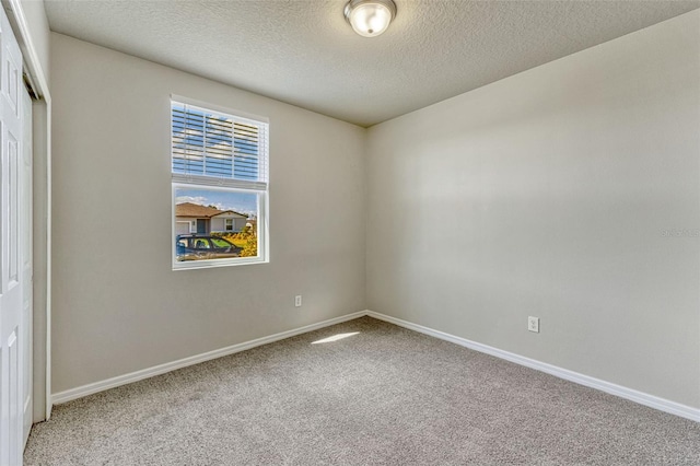 439 Sarah Nicole Way, New Smyrna Beach, FL 32168 - unfurnished room featuring light carpet, baseboards, and a textured ceiling