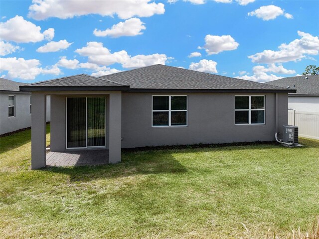 439 Sarah Nicole Way, New Smyrna Beach, FL 32168 - rear view of property with stucco siding, central AC unit, and a yard
