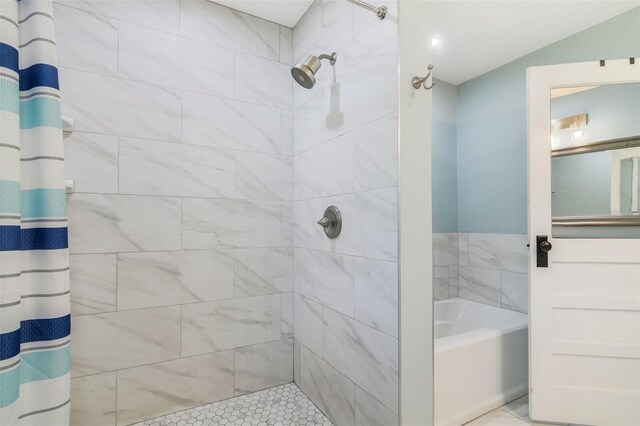 full bathroom featuring a tile shower and a bath